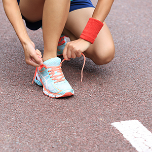 Tying up one's shoes before going on a walk or a run.