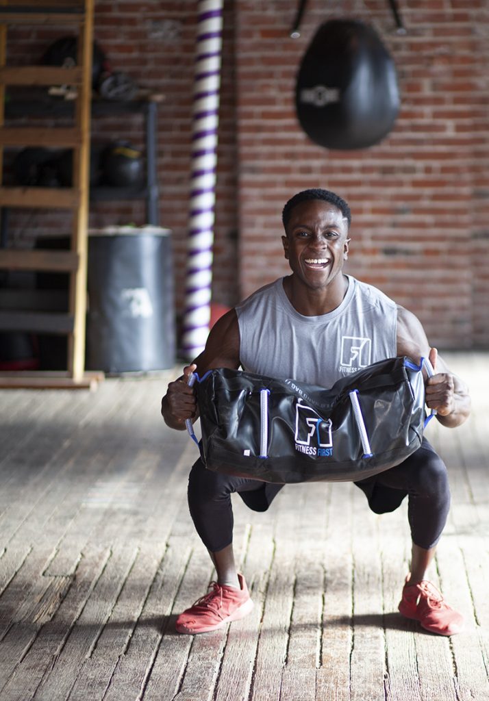 Athlete lifting the sand bag to show that +1 Mentality.