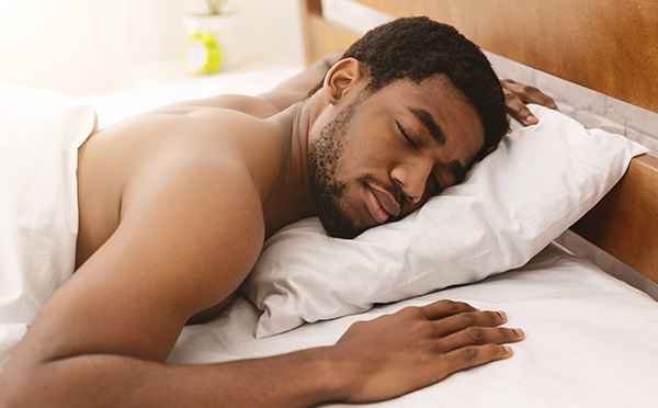 Man completing a full night's sleep and appearing refreshed.