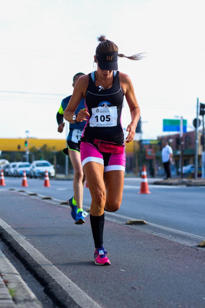 A woman runs in a race. 