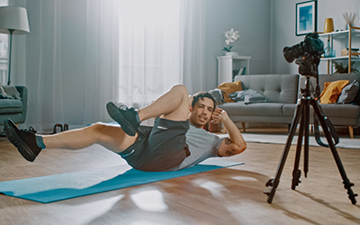 Athlete records himself doing bicycle crunches for later analysis.