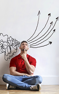 man sits on ground cross legged, chaotic image to his right is turned into ordered arrows to his left after passing through his mind.