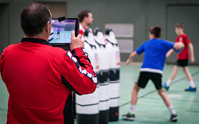 Coach records his athlete in the middle of a sport-specific activity.