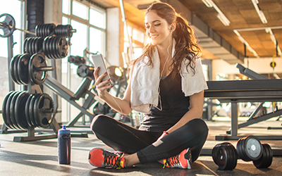 woman rests on gym floor after completing her exercise